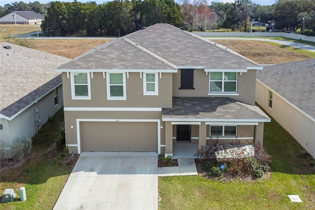 view of front of property featuring a garage and a front lawn