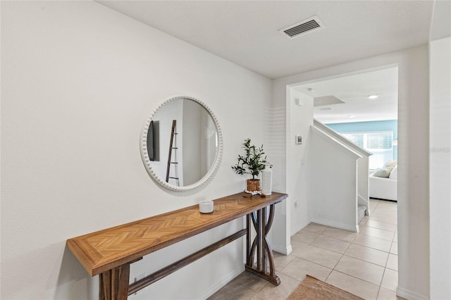 hall featuring light tile patterned floors