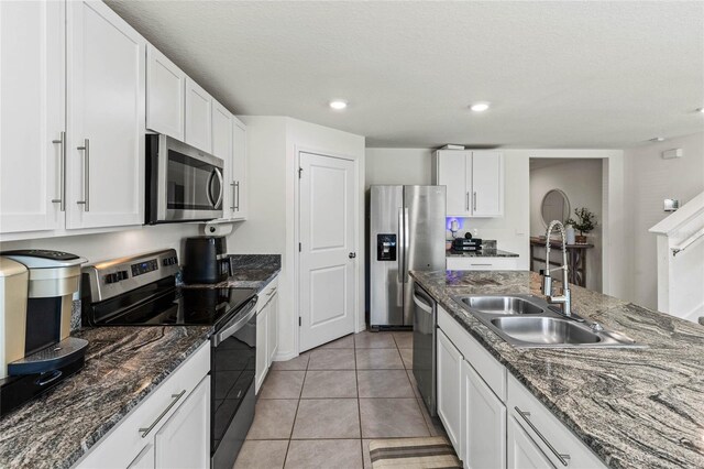 kitchen with white cabinetry, sink, and stainless steel appliances