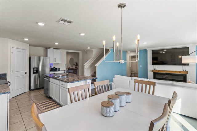 tiled dining room featuring sink