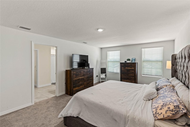 carpeted bedroom with a textured ceiling and wine cooler