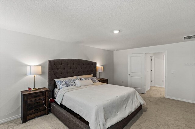 carpeted bedroom with a textured ceiling