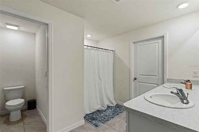 bathroom featuring a shower with curtain, vanity, a textured ceiling, tile patterned flooring, and toilet