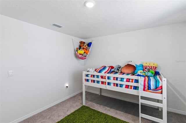 carpeted bedroom with a textured ceiling