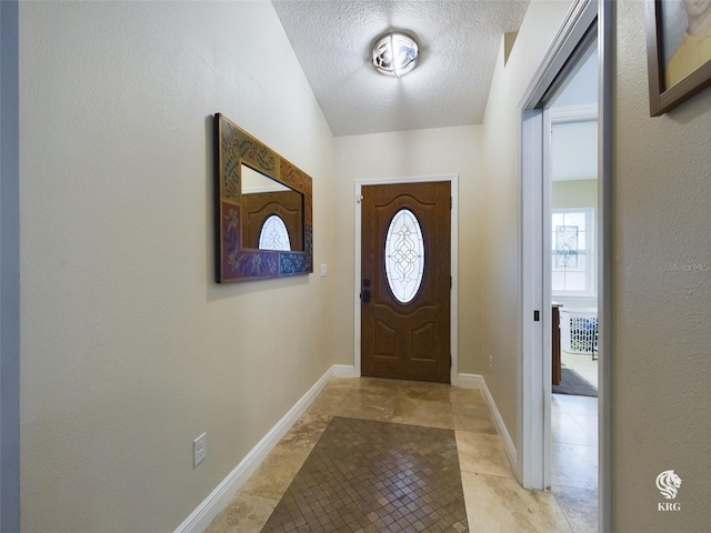 entryway featuring a textured ceiling