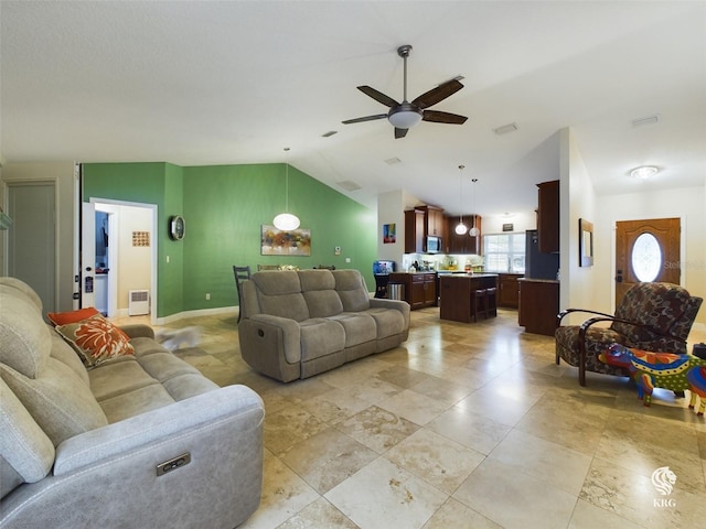 living room featuring ceiling fan and vaulted ceiling