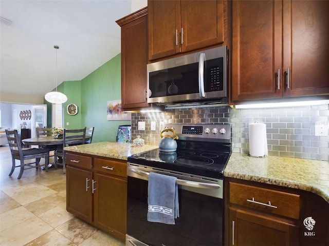 kitchen with decorative light fixtures, light stone counters, decorative backsplash, and appliances with stainless steel finishes