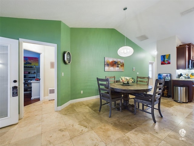 dining space with lofted ceiling