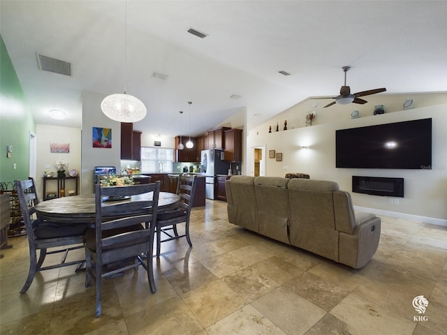 dining area featuring ceiling fan and lofted ceiling