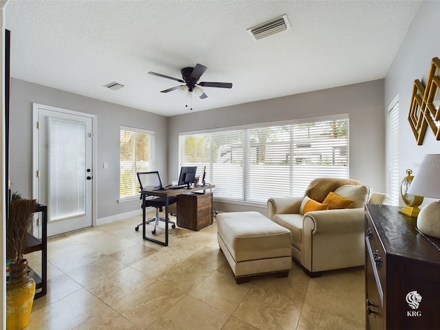 office featuring light tile patterned floors, a textured ceiling, and ceiling fan