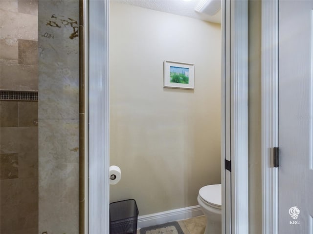 bathroom featuring tile patterned flooring, a textured ceiling, and toilet