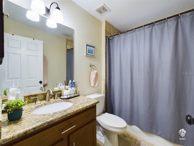 full bathroom featuring shower / bath combination with curtain, tile patterned floors, vanity, a textured ceiling, and toilet