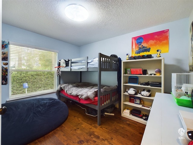 bedroom with wood-type flooring and a textured ceiling