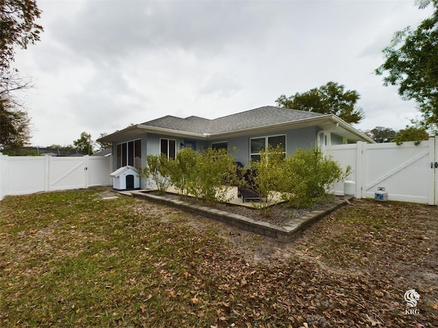 back of house with a lawn