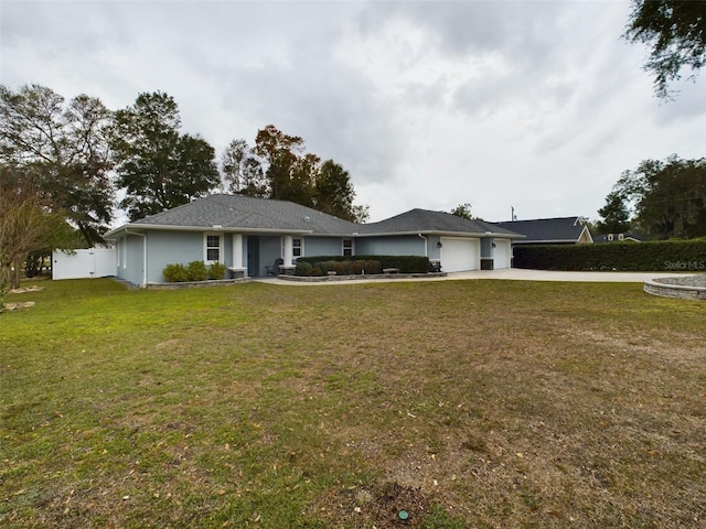 ranch-style house featuring a garage and a front lawn