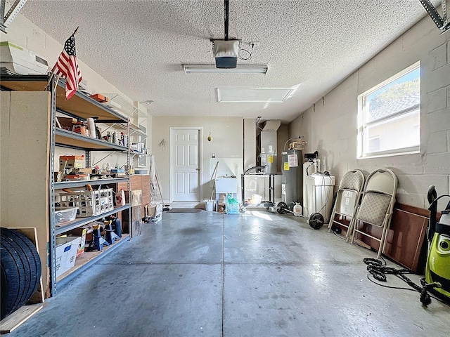 garage with electric water heater and a garage door opener