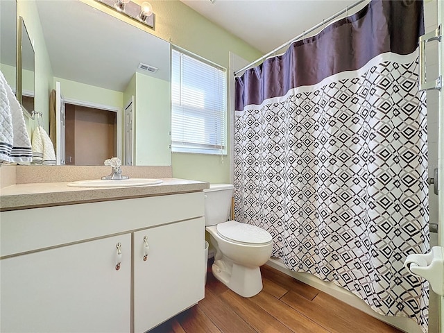 bathroom featuring hardwood / wood-style floors, vanity, and toilet