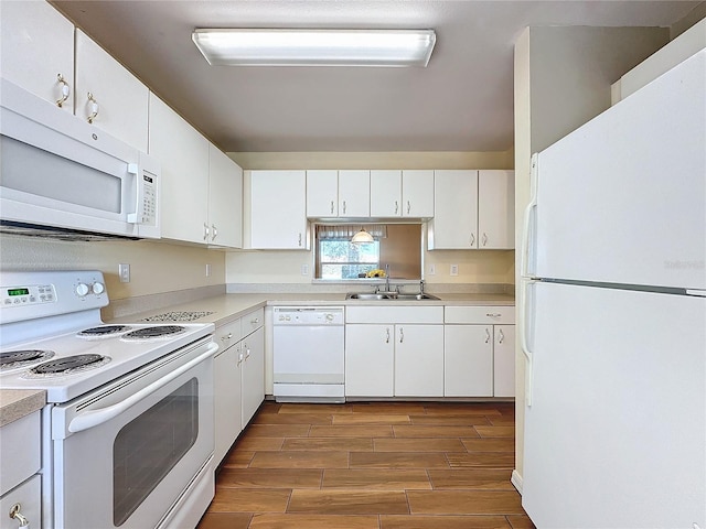 kitchen with white cabinets, white appliances, and sink