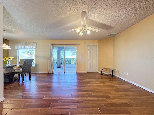 spare room featuring a wealth of natural light, ceiling fan, and a textured ceiling