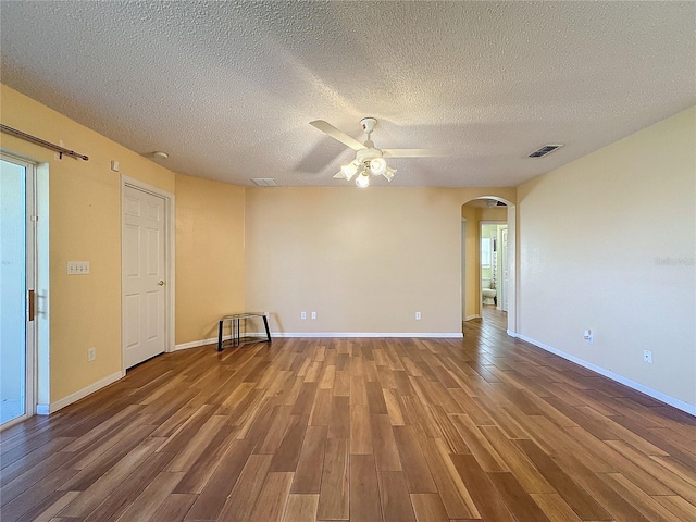 unfurnished room with hardwood / wood-style flooring, ceiling fan, and a textured ceiling