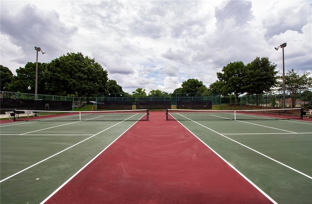 view of tennis court with basketball hoop