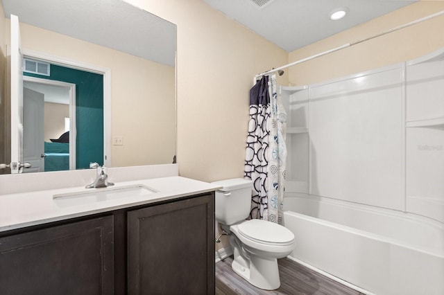 full bathroom with wood-type flooring, toilet, shower / bath combination with curtain, and vanity