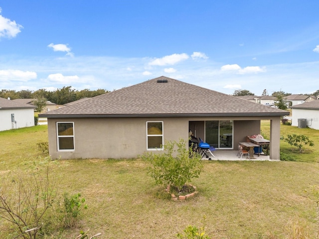 rear view of property with a yard and a patio