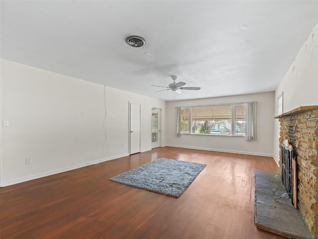 living room with ceiling fan, hardwood / wood-style floors, and a fireplace