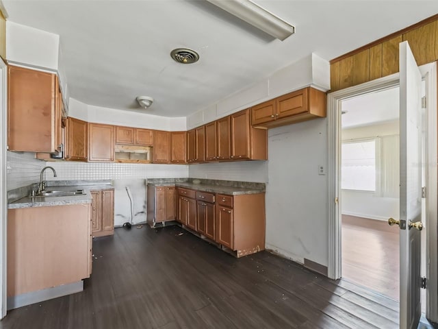 kitchen with sink, dark wood-type flooring, and tasteful backsplash