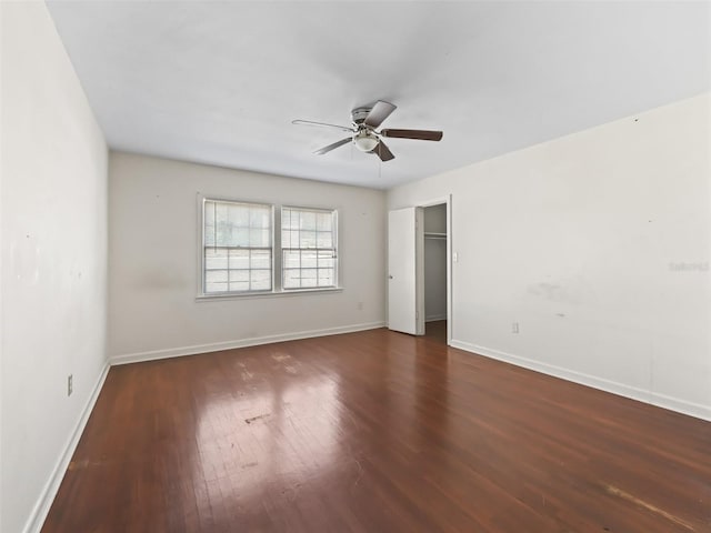 unfurnished bedroom featuring a closet, ceiling fan, and dark wood-type flooring