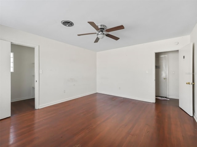 empty room with ceiling fan and dark wood-type flooring