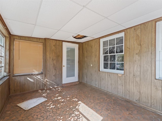 unfurnished sunroom with a drop ceiling