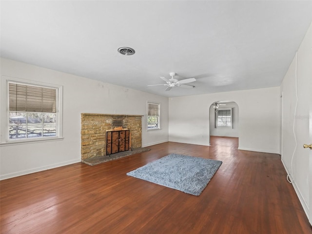 unfurnished living room with dark wood-type flooring and ceiling fan