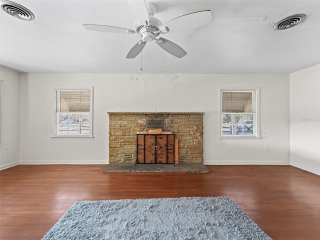 living room featuring ceiling fan, dark wood-type flooring, and a wealth of natural light