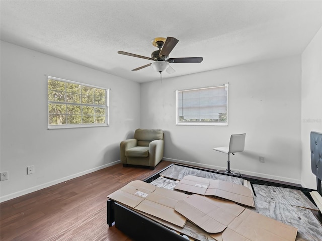 office space with ceiling fan, wood-type flooring, and a textured ceiling