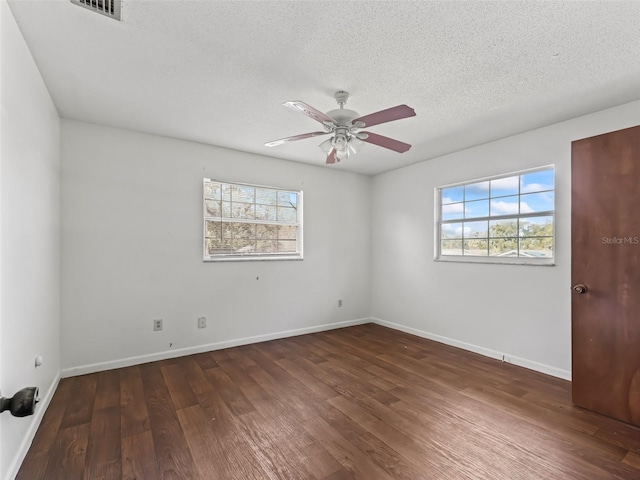 unfurnished room featuring ceiling fan, dark hardwood / wood-style floors, and a textured ceiling