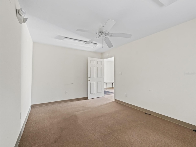 spare room with ceiling fan and carpet