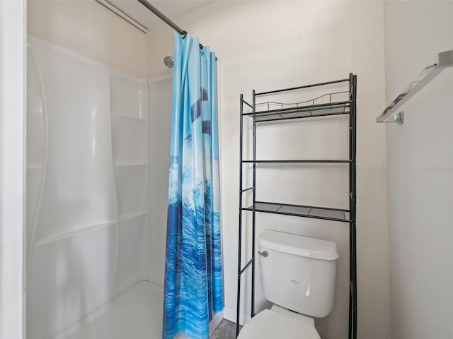 bathroom with toilet and walk in shower