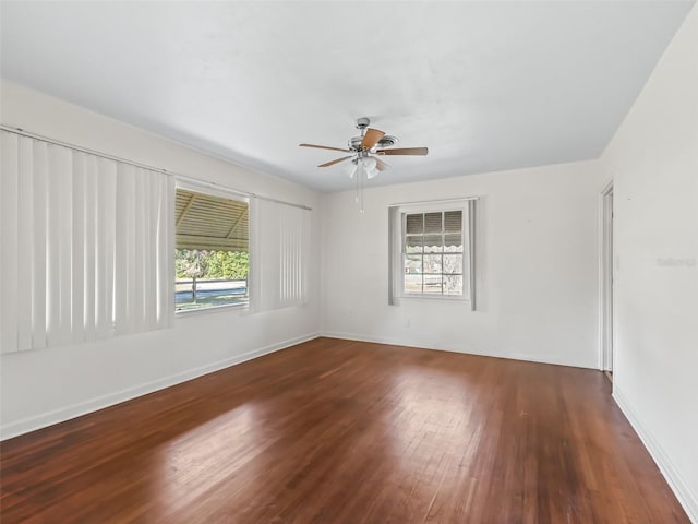 empty room with ceiling fan and dark wood-type flooring