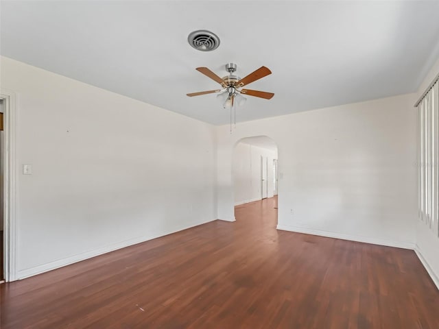 spare room featuring ceiling fan and dark hardwood / wood-style flooring