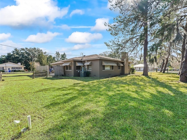 back of property featuring a lawn