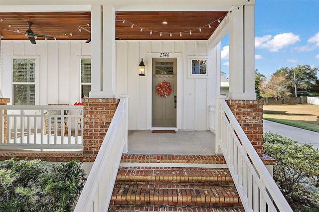 doorway to property with a porch and ceiling fan