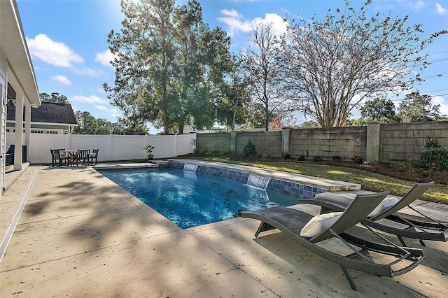 view of pool featuring pool water feature and a patio