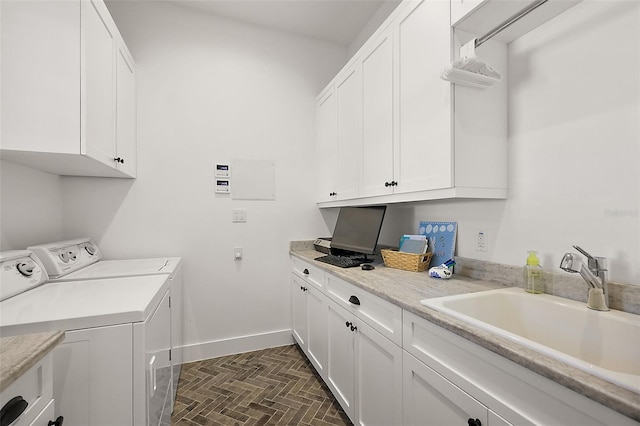 washroom featuring cabinets, sink, and washing machine and clothes dryer