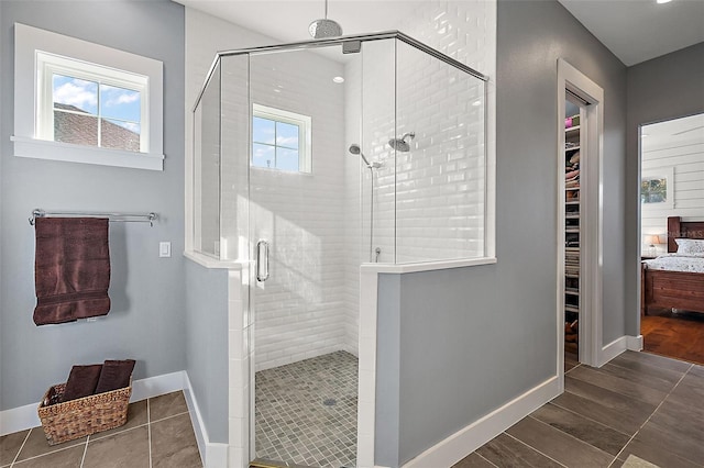 bathroom featuring plenty of natural light and a shower with shower door