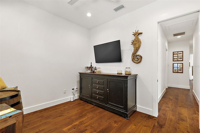 living room featuring bar area and dark hardwood / wood-style floors