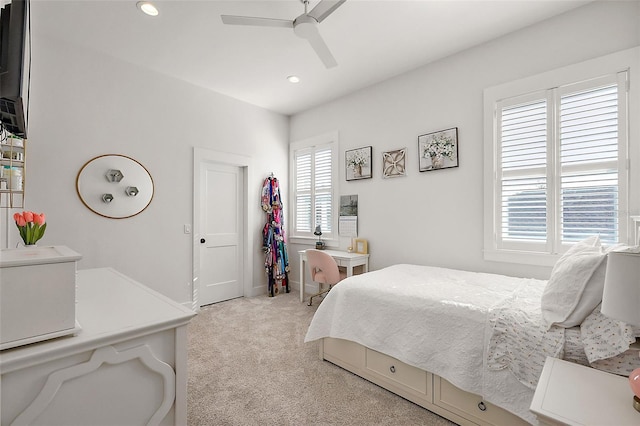 carpeted bedroom with ceiling fan and multiple windows