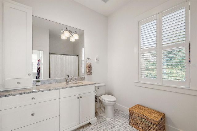 bathroom featuring tile patterned floors, walk in shower, vanity, and toilet