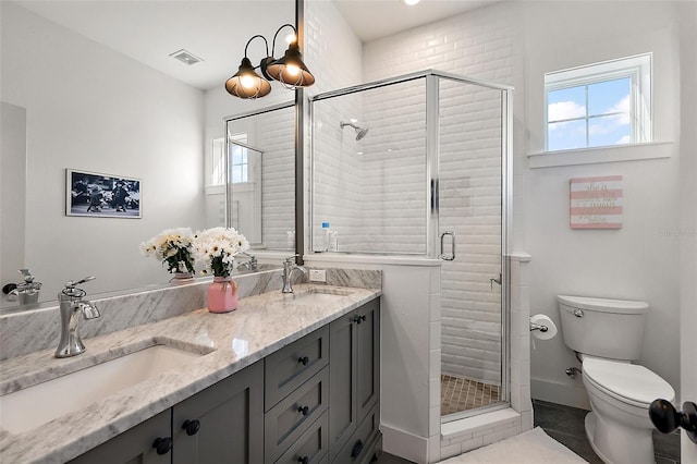 bathroom with tile patterned floors, vanity, toilet, and walk in shower