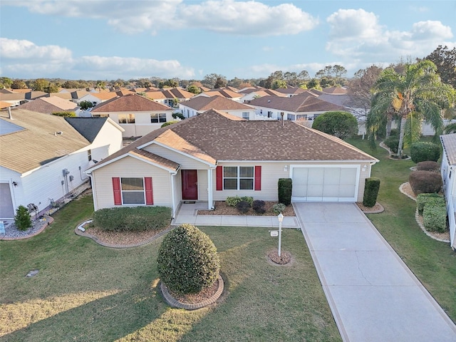 view of front of home with a front yard and a garage